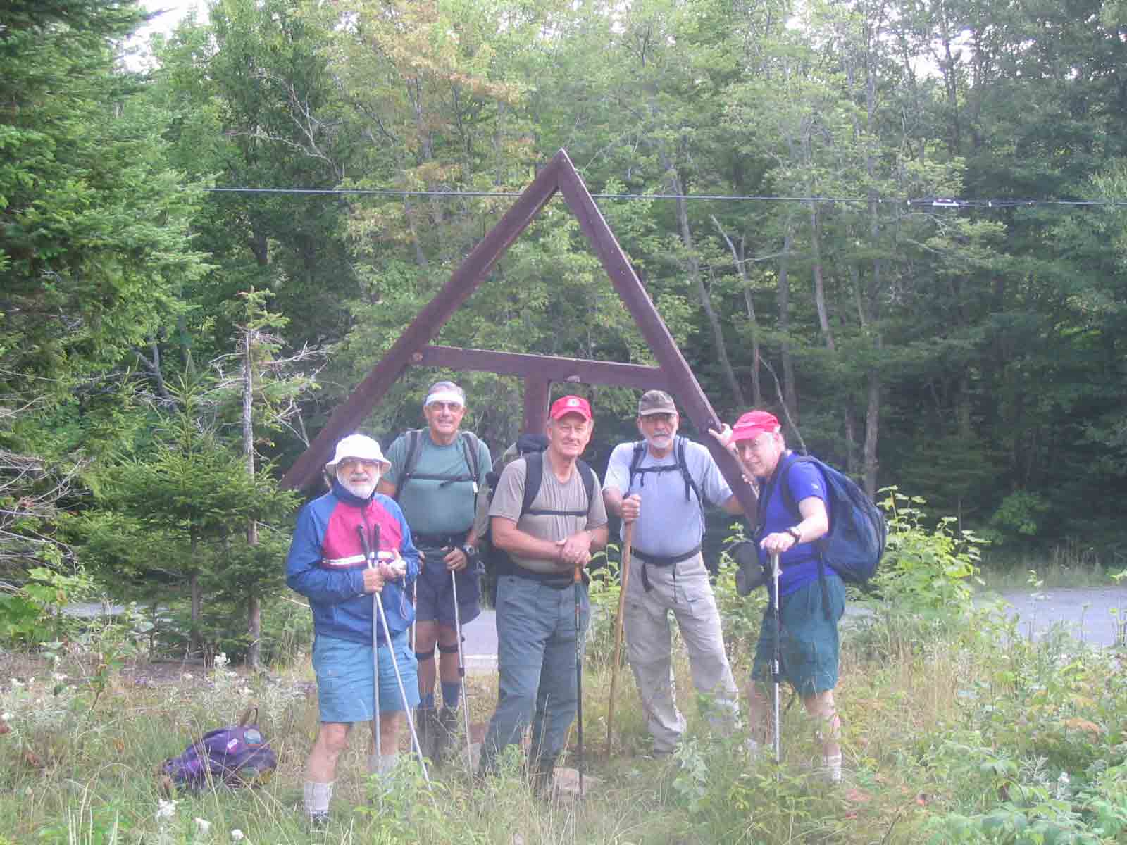 32.2 MM. This group photo was taken in the parking lot next to the big wooden AT icon just off ME 4. Parking is on the left side of the highway when approaching from Phillips. From here it is 12 miles south to Phillips and 9 miles north to Rangeley. Courtesy askus3@optonline.net